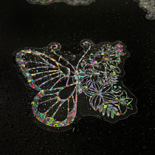 Transparent holographic butterfly laser stickers in various designs, including floral and moon elements, shown individually and in a 100-sheet pack. - Image 12