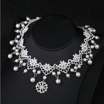 White lace choker necklace with dangling faux pearls and a central rhinestone pendant on a black jewelry bust. - Image 7