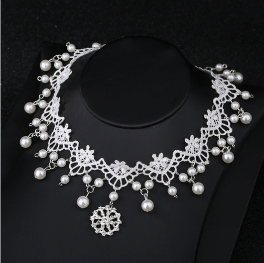 White lace choker necklace with dangling faux pearls and a central rhinestone pendant on a black jewelry bust. - Image 7