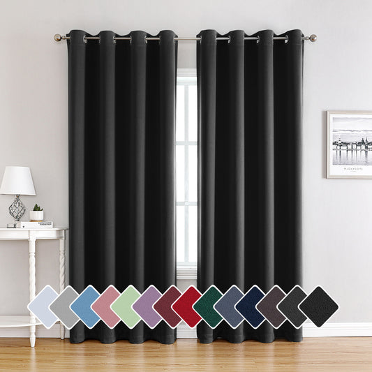 Pair of beige blackout curtains with grommet tops, made of polyester, hanging on a silver rod.