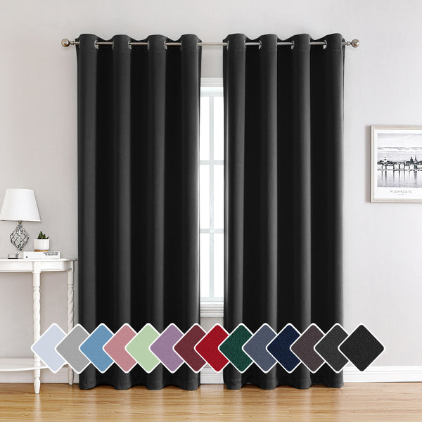 Pair of beige blackout curtains with grommet tops, made of polyester, hanging on a silver rod.