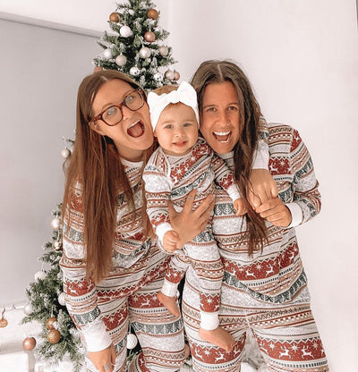 Family of four wearing matching Christmas pajamas with red, green, and white Fair Isle reindeer and snowflake pattern. - Image 5