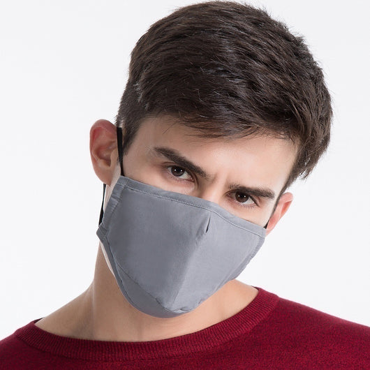 Young man wearing a black cotton face mask with adjustable ear loops, suitable for warmth and dust protection. - Image 10