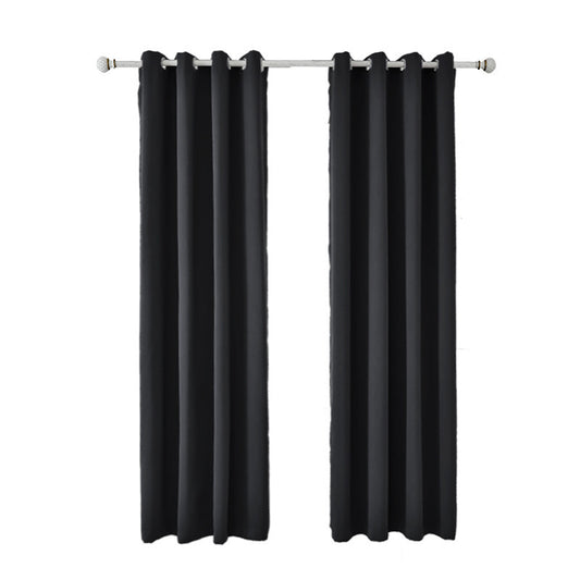 Light gray polyester blackout curtains with grommet tops hanging on a white rod in a modern living room. - Image 2