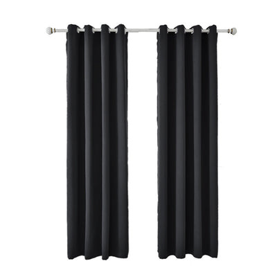 Light gray polyester blackout curtains with grommet tops hanging on a white rod in a modern living room. - Image 2