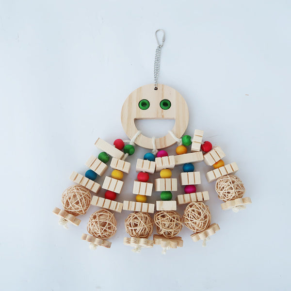 Natural wood parrot toy with a smiley face, colorful beads, wooden blocks, and rattan balls, hanging from a chain.