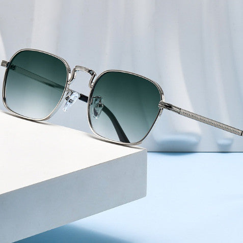 Gold frame square-oval sunglasses with gradient black and grey lenses and black temple tips on a white background.