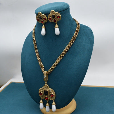 Vintage gold-toned necklace with double chain, ornate pendant featuring red and black glass inlays, and three white pearl tassels. - Image 12
