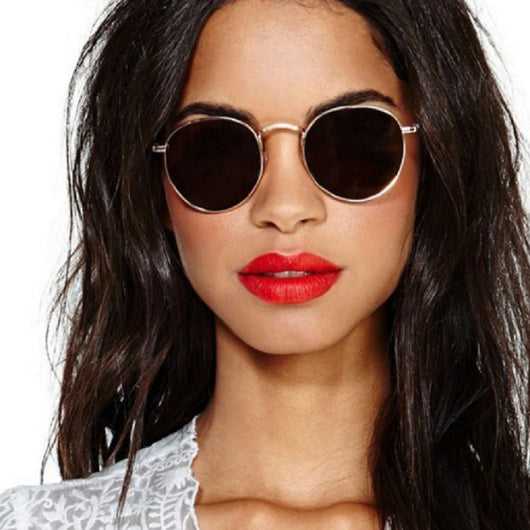 Round metallic sunglasses with iridescent green and gold lenses and a gold-colored metal frame. - Image 2