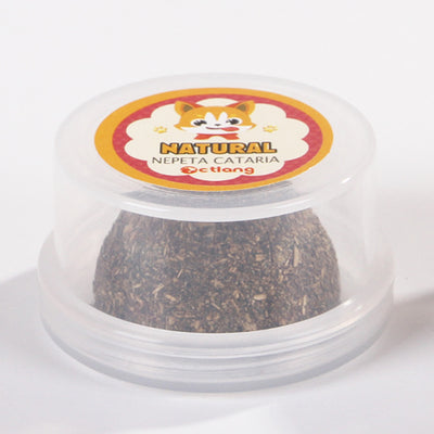 Four green cat grass or catnip balls on clear plastic bases, with a playful tabby kitten in the background. - Image 2