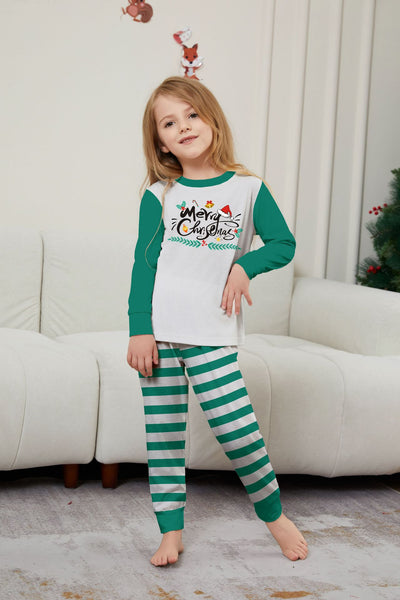 Family of four wearing matching green and white striped Christmas pajamas with "Merry Christmas" graphic. - Image 21