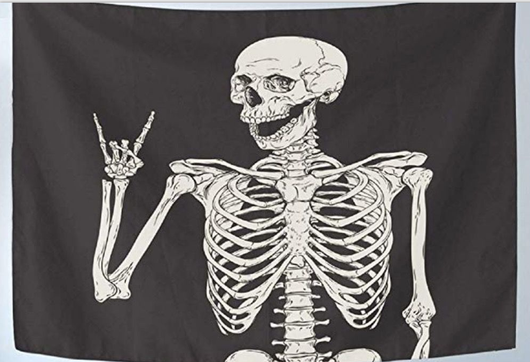 Black tapestry with a white skeleton graphic making a rock and roll hand gesture, suitable for home decor.