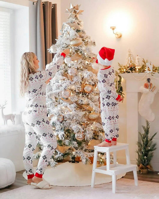 Family of six wearing matching white and red Christmas pajamas with snowflake and fair isle patterns. - Image 2