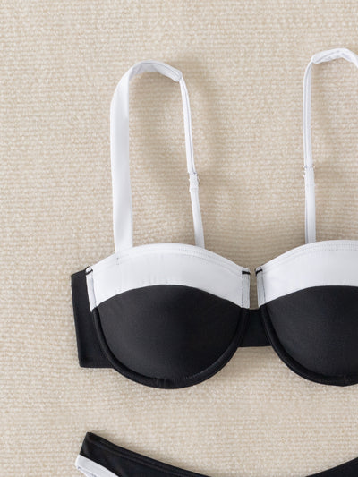 Black and white color block bikini with underwire top and high-cut bottoms, modeled by a woman by a pool. - Image 9