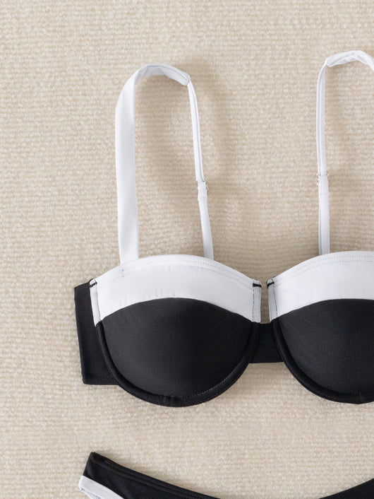 Black and white color block bikini with underwire top and high-cut bottoms, modeled by a woman by a pool. - Image 9