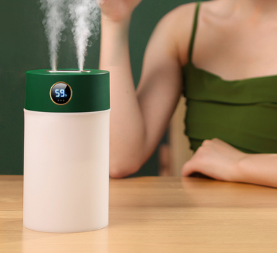 White cylindrical humidifier with a gold nozzle emitting mist, featuring a subtle bear emblem. Includes five aromatherapy oil bottles. - Image 13