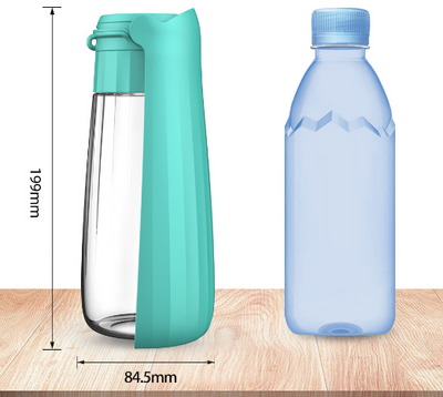 Yellow 450ml portable pet water bottle with a folding drinking trough and white wrist strap, on grass. - Image 12