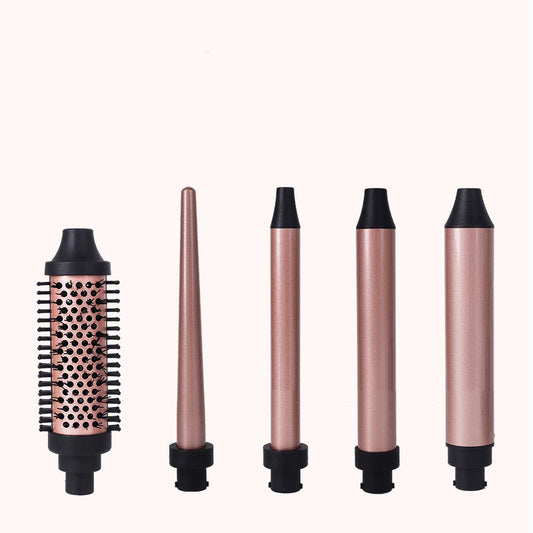 Five rose gold and black interchangeable hair styling attachments, including a round brush and various curling barrels.
