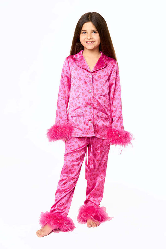 Young girl in a leopard print pajama set with black feather trim on the cuffs and ankles, wearing a pink glitter headband. - Image 8