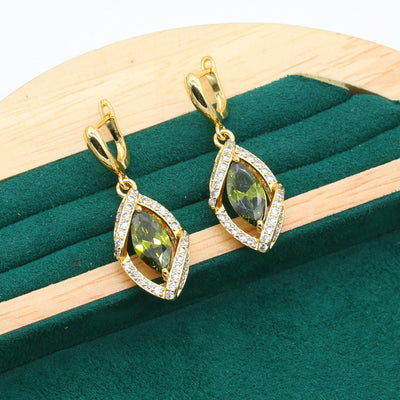 Gold-toned jewelry set with green marquise gemstones and clear accents, including a bracelet, necklace, earrings, and ring. - Image 2