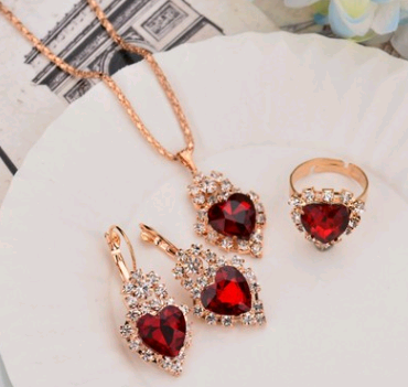 Rose gold-toned necklace, earrings, and ring set with large oval clear gemstones surrounded by smaller stones. - Image 17