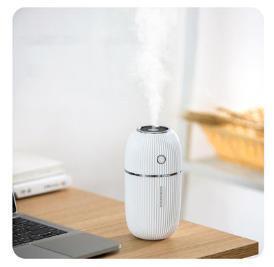 Navy blue portable humidifier with a ribbed texture, silver accents, and a power button on a white background. - Image 4