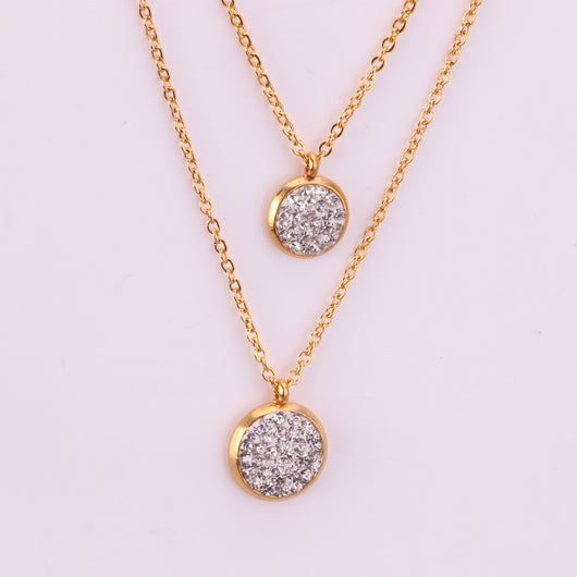 Gold plated stainless steel jewelry set with two layered necklaces and matching stud earrings. Features round crystal-studded pendants. - Image 3