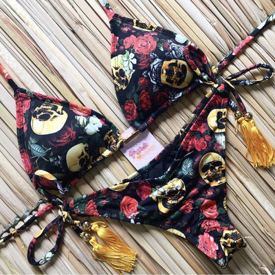 Women's tropical floral print bikini with a halter top, ruffled edges, and tie-side bottoms with pink tassels. - Image 7