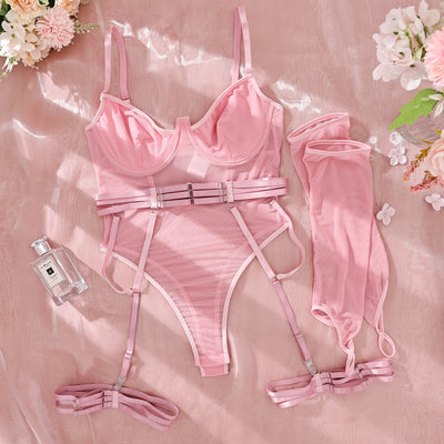 Pink mesh see-through jumpsuit with garter straps and matching arm sleeves, laid flat on a pink background. - Image 9