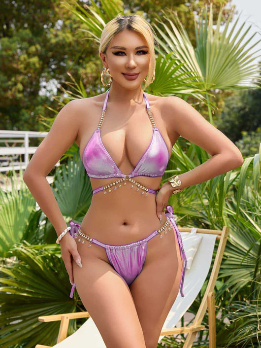 Iridescent purple and pink two-piece bikini with gold-toned crystal embellishments on a white faux fur background. - Image 19