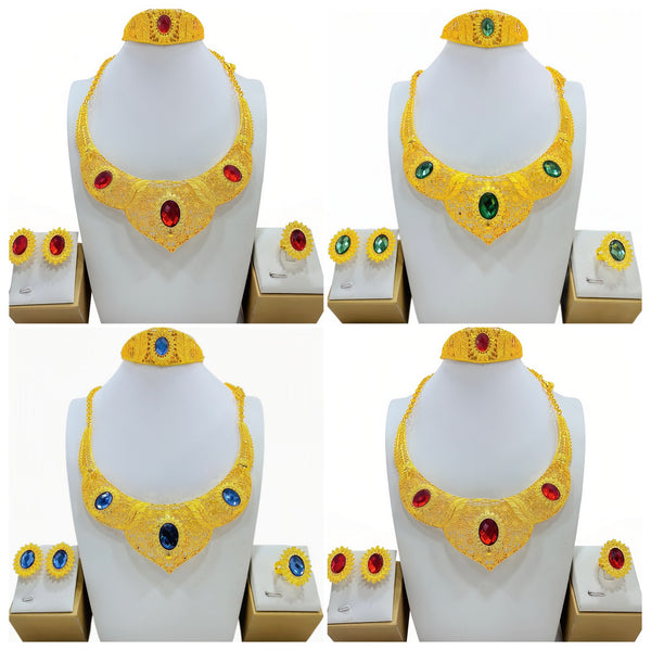 Golden jewelry set with a wide necklace, cuff bracelet, stud earrings, and ring, all featuring blue oval gemstones and intricate filigree patterns.