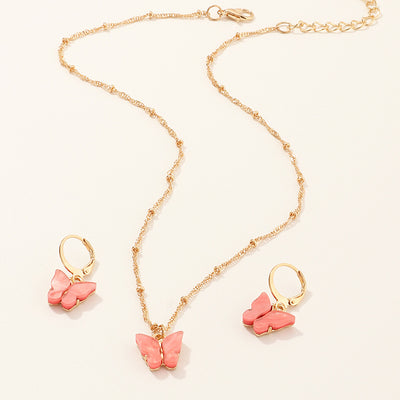 Blue resin butterfly necklace and earring set with gold-tone chains and findings, displayed on a light background. - Image 9