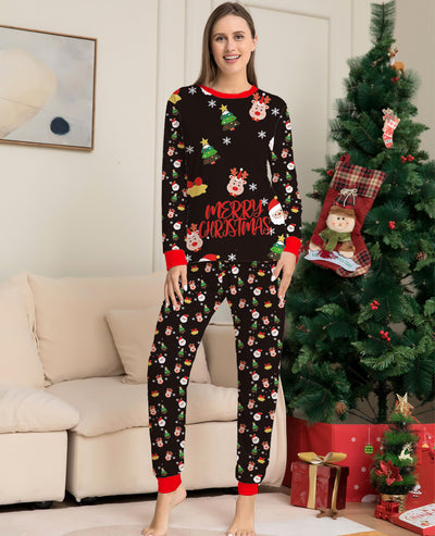 Man wearing a black long-sleeve Christmas pajama set with Santa, reindeer, and Christmas tree patterns. - Image 3
