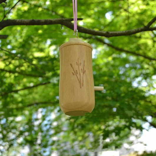 Light brown wooden birdhouse with a conical roof, circular entrance, perch, and etched branch design, hanging hook. - Image 11
