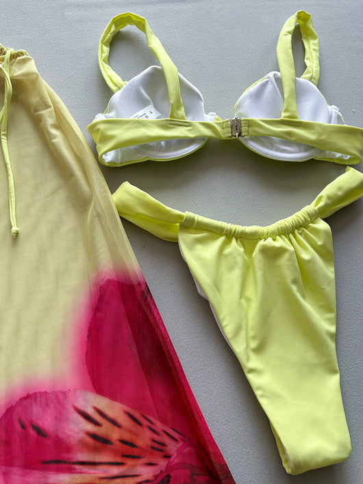 Woman in a light yellow three-piece bikini with an underwire top, matching bottoms, and a sheer floral sarong skirt. - Image 11