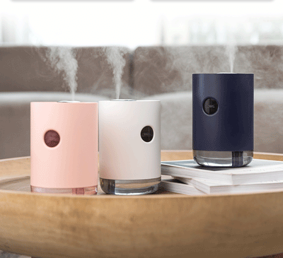 White cylindrical humidifier with a transparent base, digital display, and 1000ml capacity indicator.