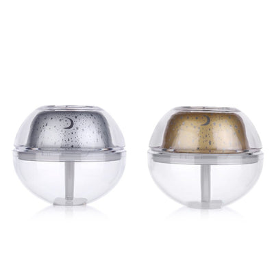Silver and clear spherical essential oil diffuser with a starry night LED projector, featuring moon and star patterns. - Image 2