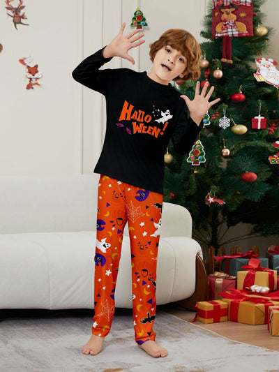 Family of four wearing matching black and orange Halloween long-sleeve pajamas with ghost and bat prints. - Image 16