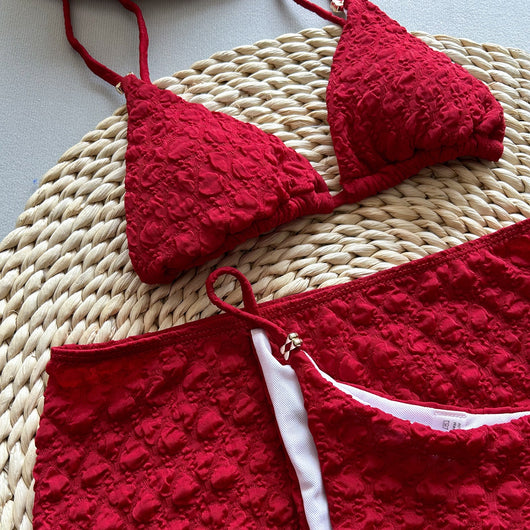 Red textured three-piece women's swimsuit set with triangle bikini top, thong bottom, and matching mini skirt. - Image 8