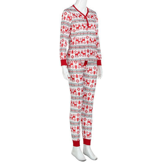 Family of four and a dog wearing matching long-sleeved Christmas pajamas with red reindeer and green snowflake print. - Image 2