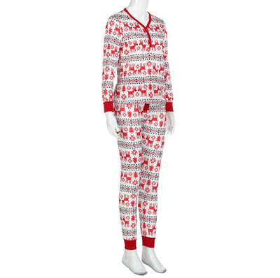 Family of four and a dog wearing matching long-sleeved Christmas pajamas with red reindeer and green snowflake print. - Image 2