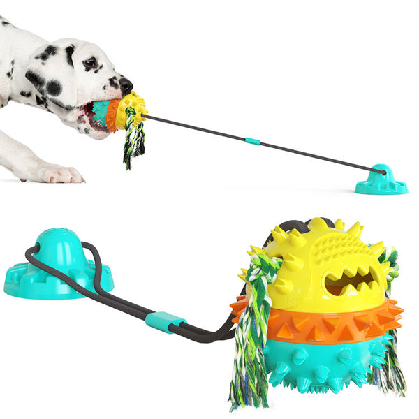 Red, white, and blue textured dog chew toy with rope tassels and a blue suction cup base, shown with a Dalmatian puppy playing. - Image 2