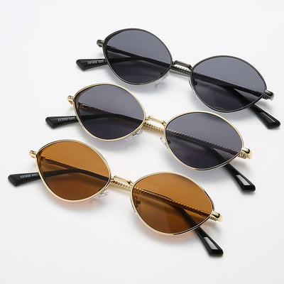 Oval women's sunglasses with dark gray lenses and a gunmetal metal frame, featuring textured temples. - Image 3