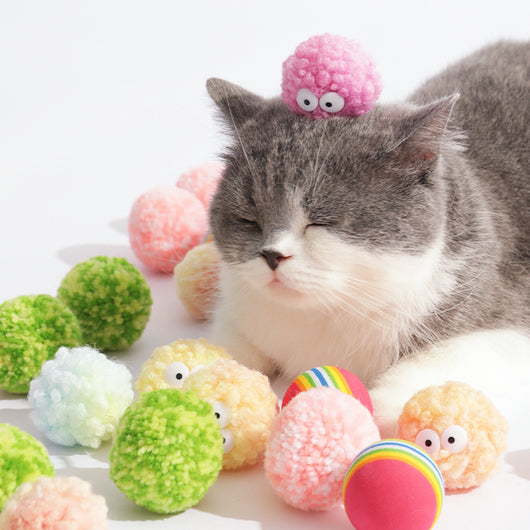 Assortment of soft, colorful yarn ball dog toys with built-in bells, featuring various patterns and textures. - Image 6
