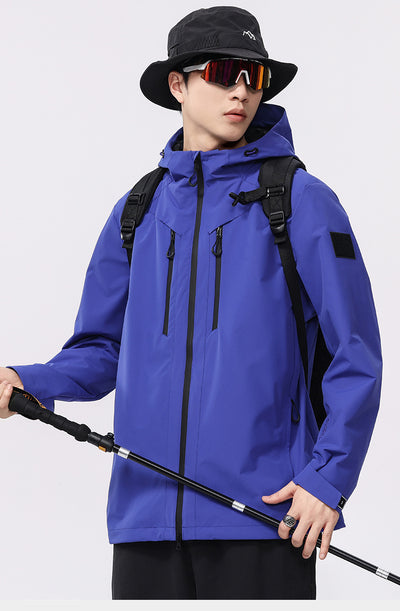 Man wearing a black windproof and waterproof outdoor jacket with a hood, sports sunglasses, and a bucket hat, holding a trekking pole. - Image 16