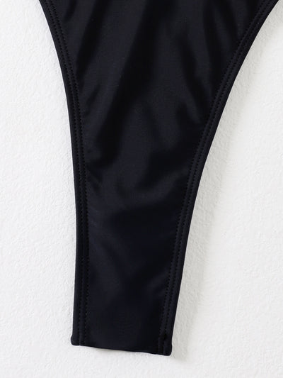 Black two-piece swimsuit with a bandeau top featuring a central O-ring, cut-out, and white zigzag embroidered trim, paired with matching high-cut bikini bottoms - Image 9