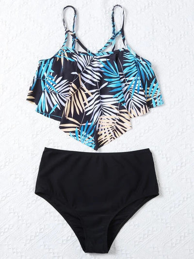 Women's split swimsuit with a black high-waisted bikini bottom and a flounced tankini top featuring a green, blue, and white tropical leaf print. - Image 17