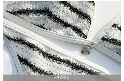 White and black striped bikini with triangle-cut top and tie-side bottom, modeled outdoors. - Image 25