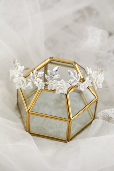 Silver-toned hair band with white ceramic flowers, faux pearls, and delicate silver leaves, perfect for bridal wear. - Image 3