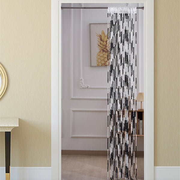 Brown and beige striped string curtain with twisted tassel texture, held by a hand, for living room partition.